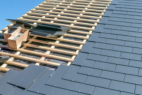 Close-up of slate roof tiles being installed